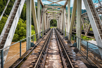 Railroad bridge that stretches across the mountain river
