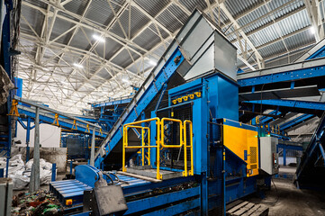 Fototapeta premium Machine for compacting household waste. Compaction of garbage into briquettes and bales.