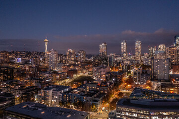 Fototapeta na wymiar Seattle, Washington, USA - November 2022, night aerial view of illuminated Seattle Downtown and the Waterfront pier area with famous Space Needle Tower - aerial night view 