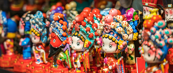 Fototapeta na wymiar A row of traditional Chinese handicrafts Peking Opera mask dolls