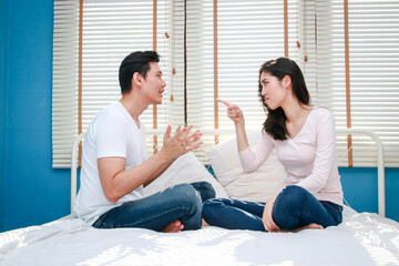 Family concept. Asian couple arguing in bed Feeling unhappy in a married life. couple problems