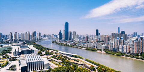 Sunny day scenery of Qintai Grand Theater and Han River in Wuhan, Hubei, China © Govan