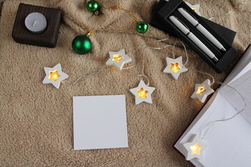 The pen is on the table. Coffee, a wooden tray of cinnamon, and a candle are strewn nearby. Morning. Postcard for the inscription of wishes.