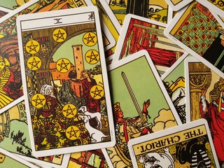 Picture of the Ten of Pentacles tarot card from the original Rider Waite tarot deck with mixed tarot cards in the background