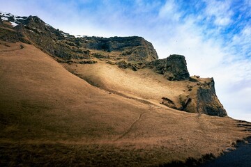 View of clifftop slopes under the blue sky in Iceland