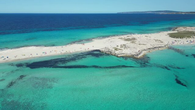 Aerial shot of Formentera, Ibiza, Spain, with people on the beach and yachts in the water