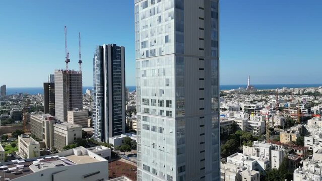 Tel Aviv skyline, beach and buildings. Israel TLV city drone shot. Buildings and cranes all around.
