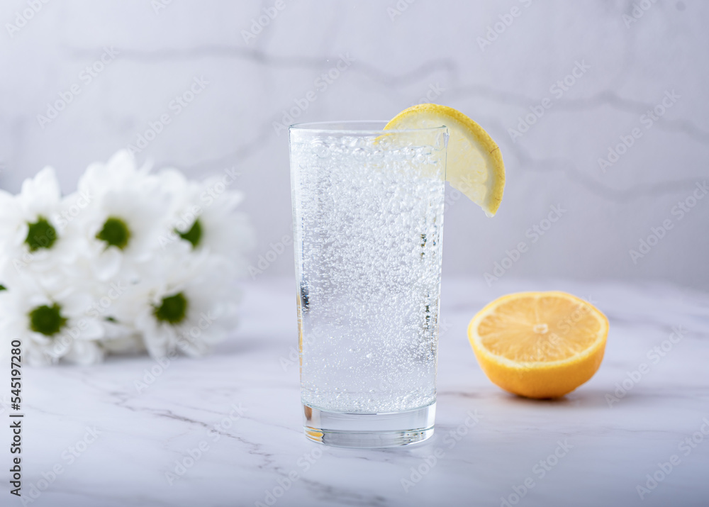 Wall mural glass of refreshing carbonated mineral water and a slice of lemon.