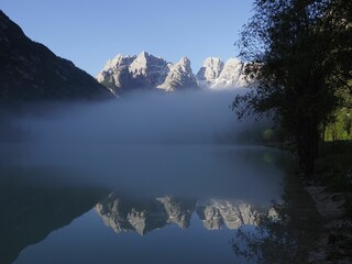 Mountain peak reflecting on the lake with misty weather