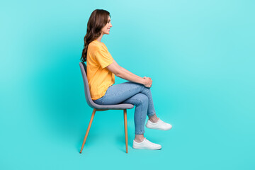 Full length photo of pretty shiny lady wear yellow t-shirt looking empty space sitting chair...