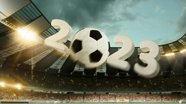 Flight of soccer football ball through crowded stadium with spotlights in evening time. Concept of sport, art, energy, power. Unfocus effect. 2023 New year