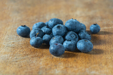 Fresh, healthy sweet blueberry fruits on wooden board