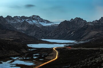 Sichuan Tibet highway with light trails near the Sister lakes with light trails © Kazushi/Wirestock Creators