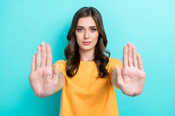 Photo of confident pretty lady wear yellow t-shirt showing arms palms asking stop isolated...
