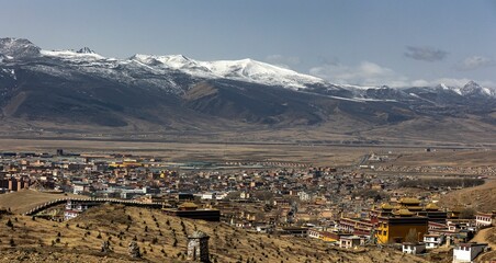 Panoramic view of a picturesque city of Litang, Sichuan, China, surrounded by snowy mountains