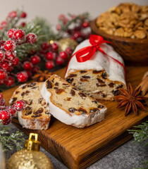 Christmas stollen - traditional german bread on black marble texture. Festive dessert made of dough, nuts and marzipans sprinkled with powdered sugar.Copy space. Place for text.