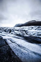Foto op Plexiglas Vertical shot of a landscape covered with ice and glaciers in Iceland © Callum Ludlow/Wirestock Creators