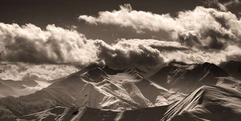 Sepia evening mountains and sunlight clouds