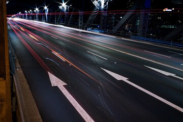 Long exposure shot of illuminated bridge at night © Adrian Studt/Wirestock Creators
