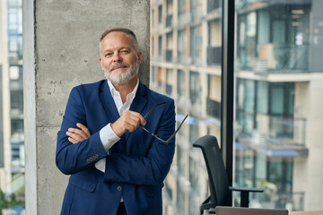 Cheerful businessman relaxing during free time at work