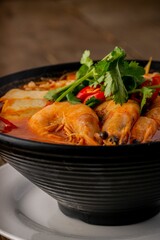 Vertical shot of a shrimp soup in a bowl