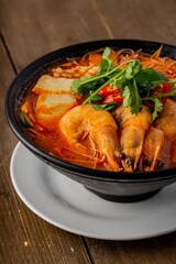 Vertical shot of a shrimp soup in a bowl