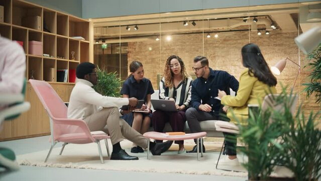 Diverse Group of People Talking in a Casual Modern Meeting Room in Office. Group of Colleagues From Different Ethnicities Working Together as a Team on Crisis Management. Zoom Out Wide Shot