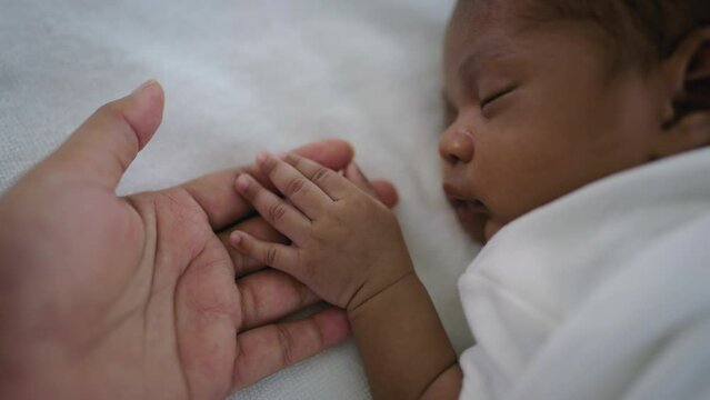Parent hands holding newborn african black baby fingers, Close up mother's hand holding their new born baby. Together love family healthcare and medical, father's day and mother's day concept.