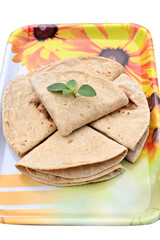 closeup the bunch brown color tortilla with green mint in the yellow white plastic tray on the white background.