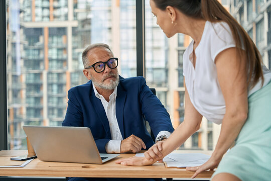 Female and male colleage with romantic relationship in office