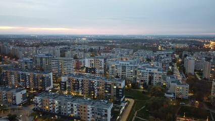 Aerial view of a city panorama of Wroclaw, Poland, during the sunset, with street lights turned on