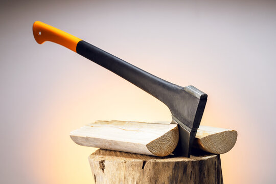  An axe in the stump with chopped firewood. Concept of firewood preparation for winter.