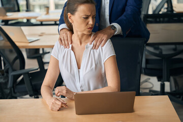 Businesswoman experiencing harrasment from male collegue in office