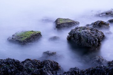 Long exposure view of the waves touching the stones in the water