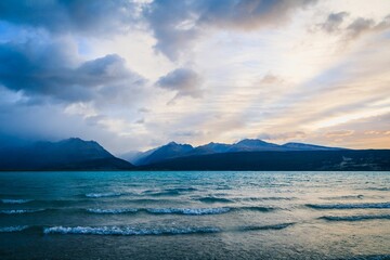 Scenic view of Lake Pukaki against mountains in Glentanner, New Zealand at sunset
