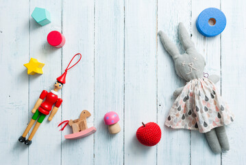 classic toys on faded white wooden frame background