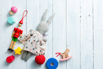 classic toys on faded white wooden frame background