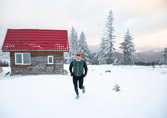 trail runner with frozen beard training in winter landscape