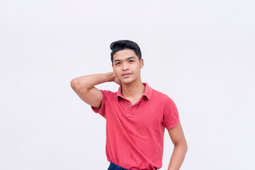 A confident and cocksure young man in a nice fitting red polo shirt. Isolated on a white background.