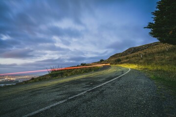 Empty country road against the background of cloudy sky in the evening. Christchurch, New Zealand.
