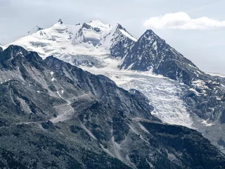 Foto op Plexiglas Beautiful shot of snowy mountain peaks under a bright sky in Switzerland © Cg6/Wirestock Creators