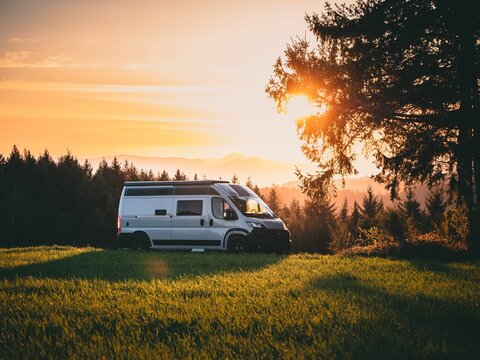 Dazzling sunset view with a campervan parked in the Black Forest Mountains in Germany