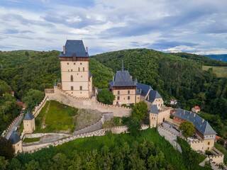 Fototapeta na wymiar Gothic architecture style Karlstejn Castle on the green hill, Bohemia, Czech Republic, aerial view