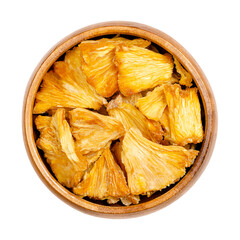 Dehydrated pineapple pieces, in a wooden bowl. Chunks of dried fruits of Ananas comosus, used as...