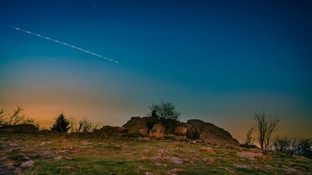 Shining meteor passing through the starry sky over the Taunus forest in Germany