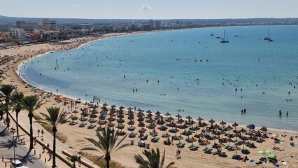 Obraz premium Aerial view of people vacationing at Playa de Palma beach resort in Mallorca, Spain