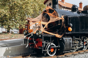 Entrevaux, France - 30.10.2022 :  the 1920s vintage steam train in Provence decorated for Halloween