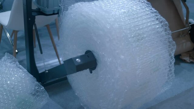 A roll of bubble wrap for wrapping and safely transporting fragile items. Shot in motion. Closeup