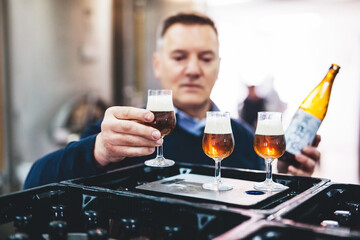 Man tasting craft beer from brewery.