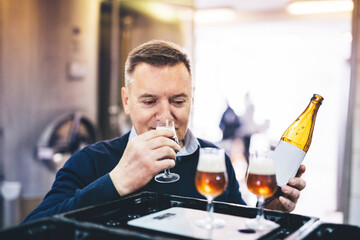 Man tasting craft beer from brewery.